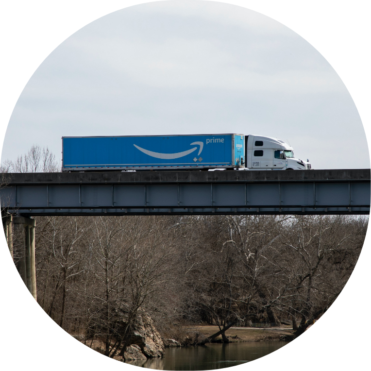 An Amazon truck on a bridge.